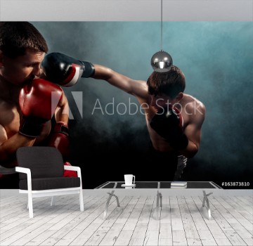 Picture of Two professional boxer boxing on black smoky background